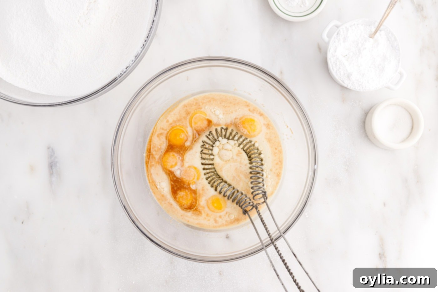 Whisking egg yolks with oil, milk, and extracts for chiffon cake batter