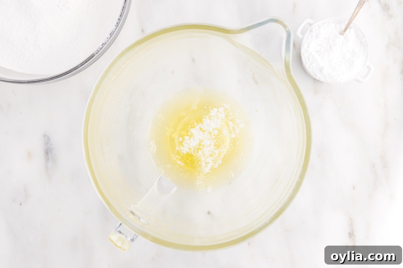 Egg whites and cream of tartar starting to whip in a stand mixer bowl