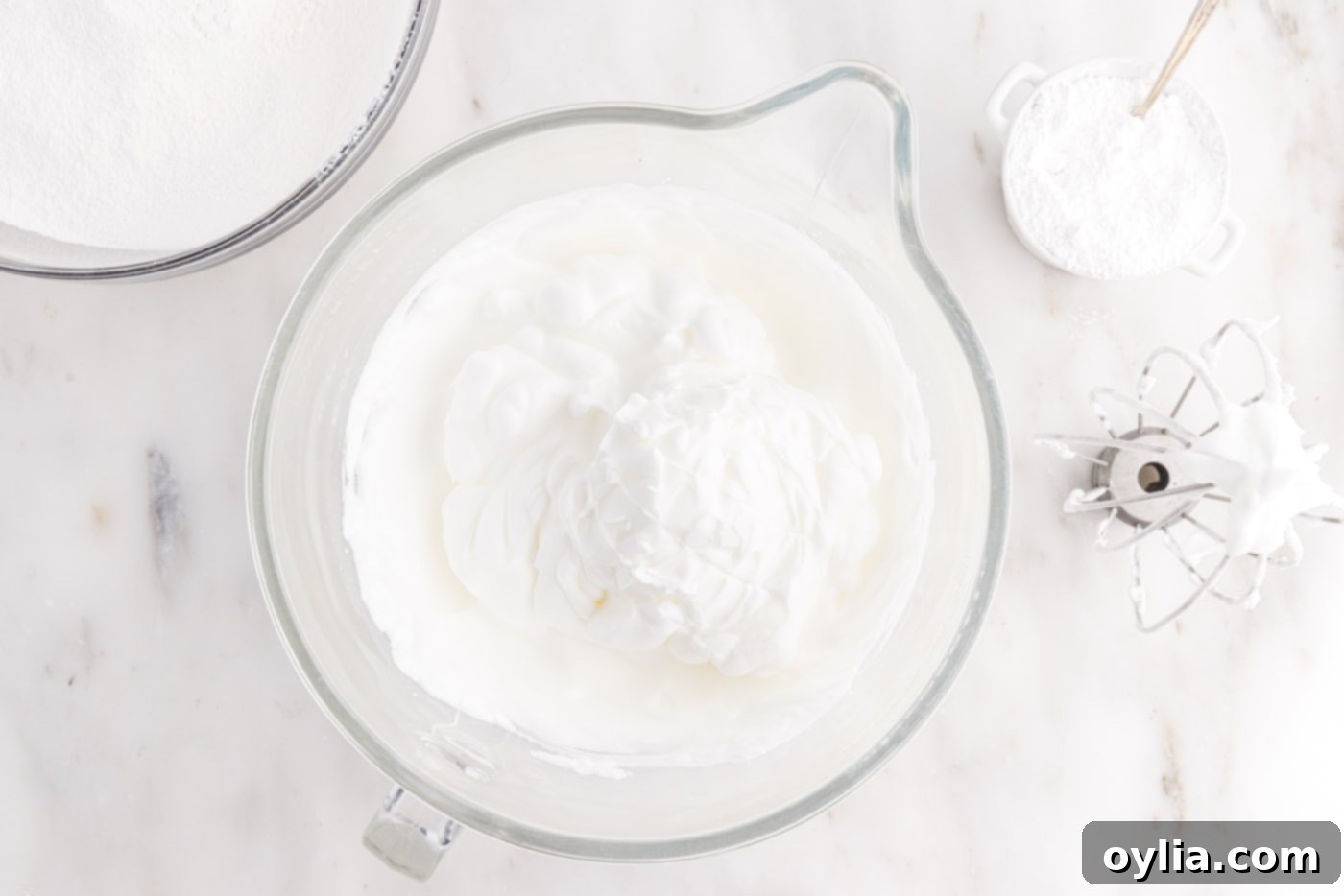 Perfectly whipped egg white meringue with stiff peaks in a stand mixer