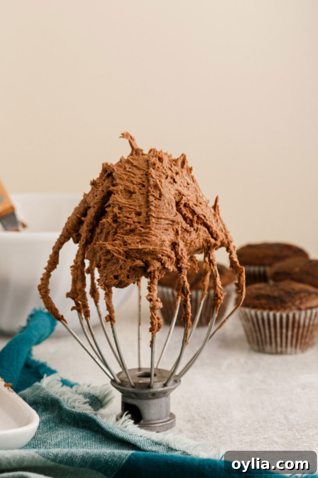 Chocolate Buttercream Frosting on a mixer whisk