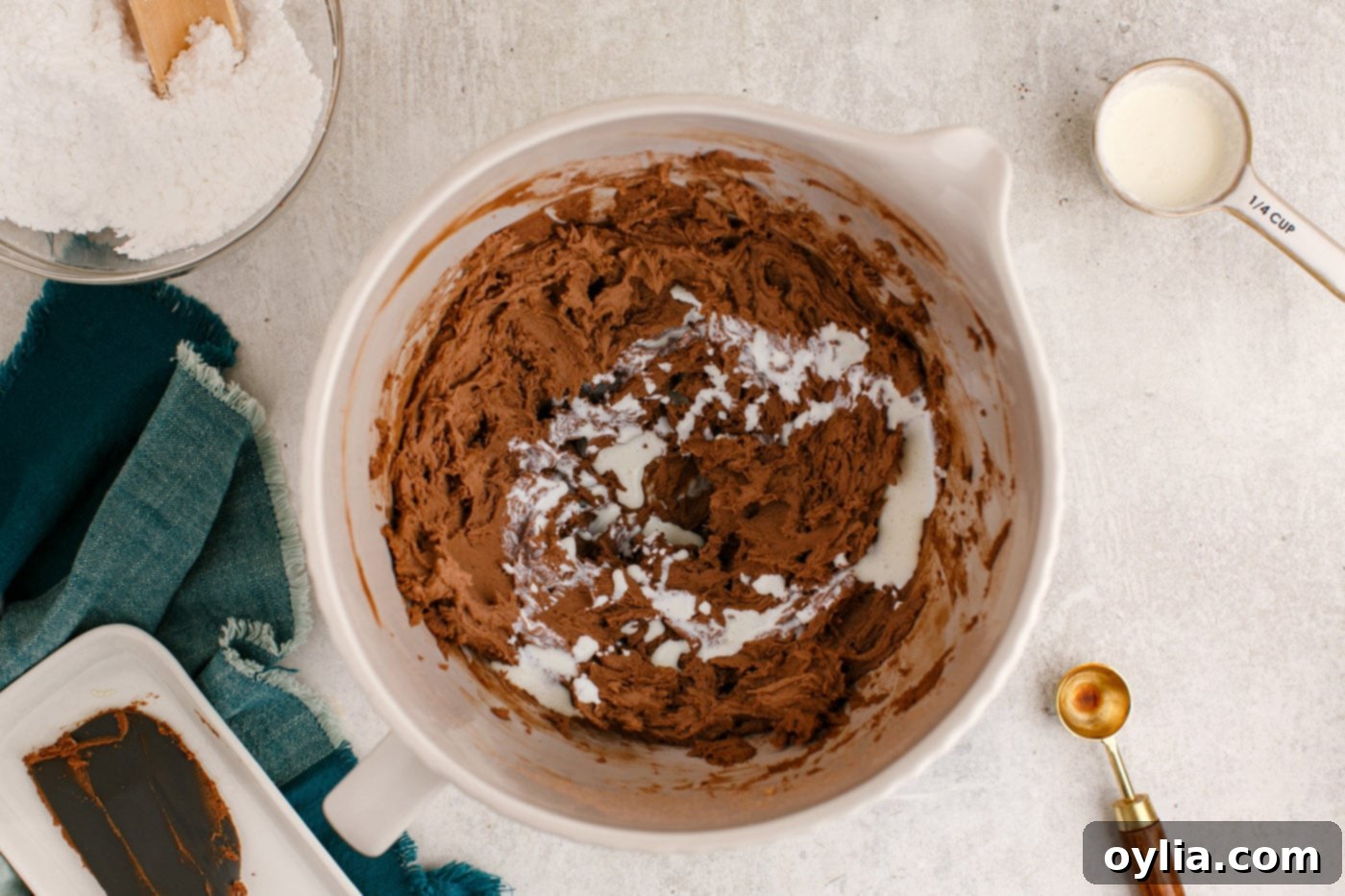 adding heavy cream to chocolate buttercream frosting