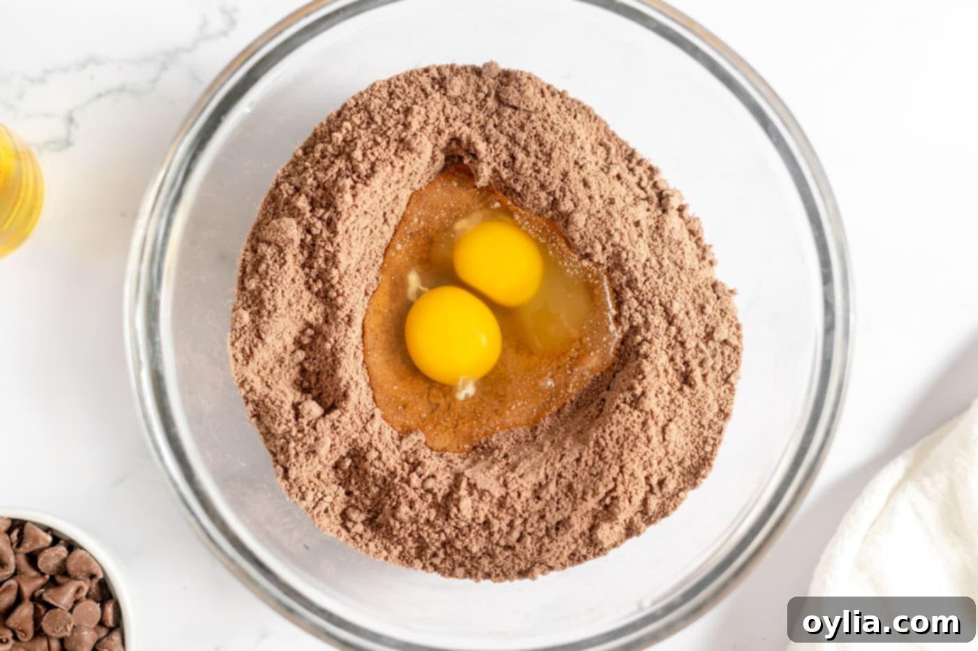 eggs in the center of cake mix in a bowl