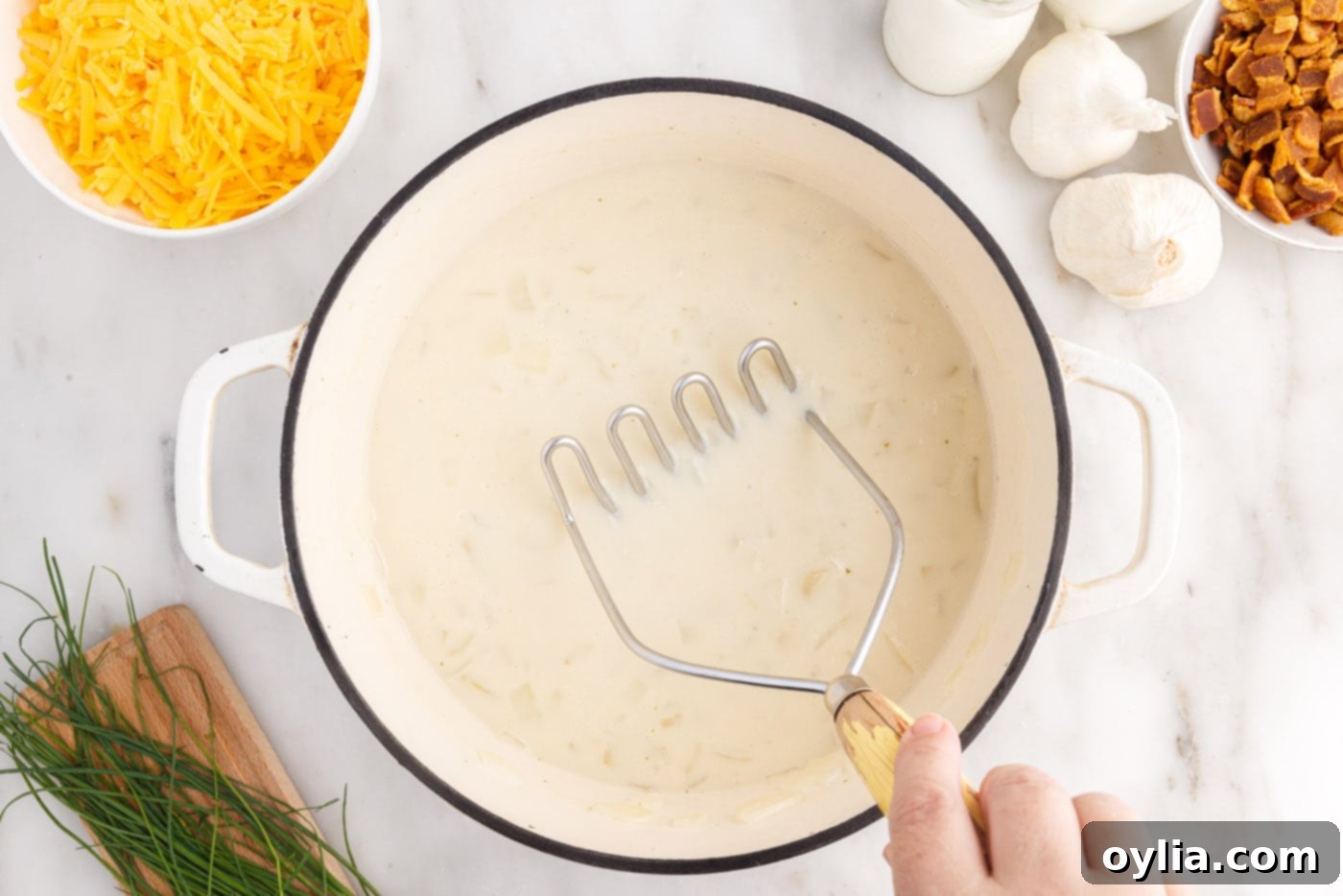 using a mashed to break up chunks of potato in soup