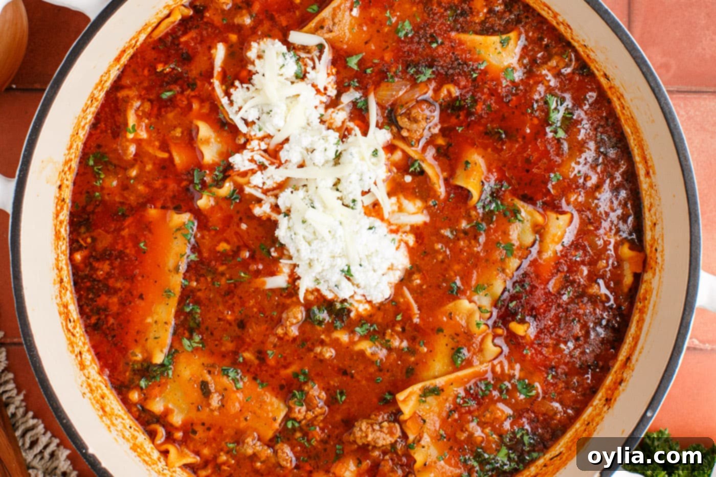 lasagna soup in a pot with three cheese mixture