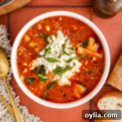 Bowl of Lasagna Soup topped with cheese mixture and parsley