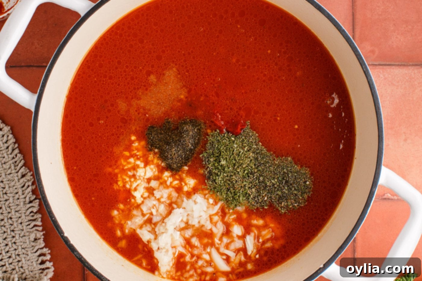 Italian herbs and seasonings added to marinara with beef and sausage