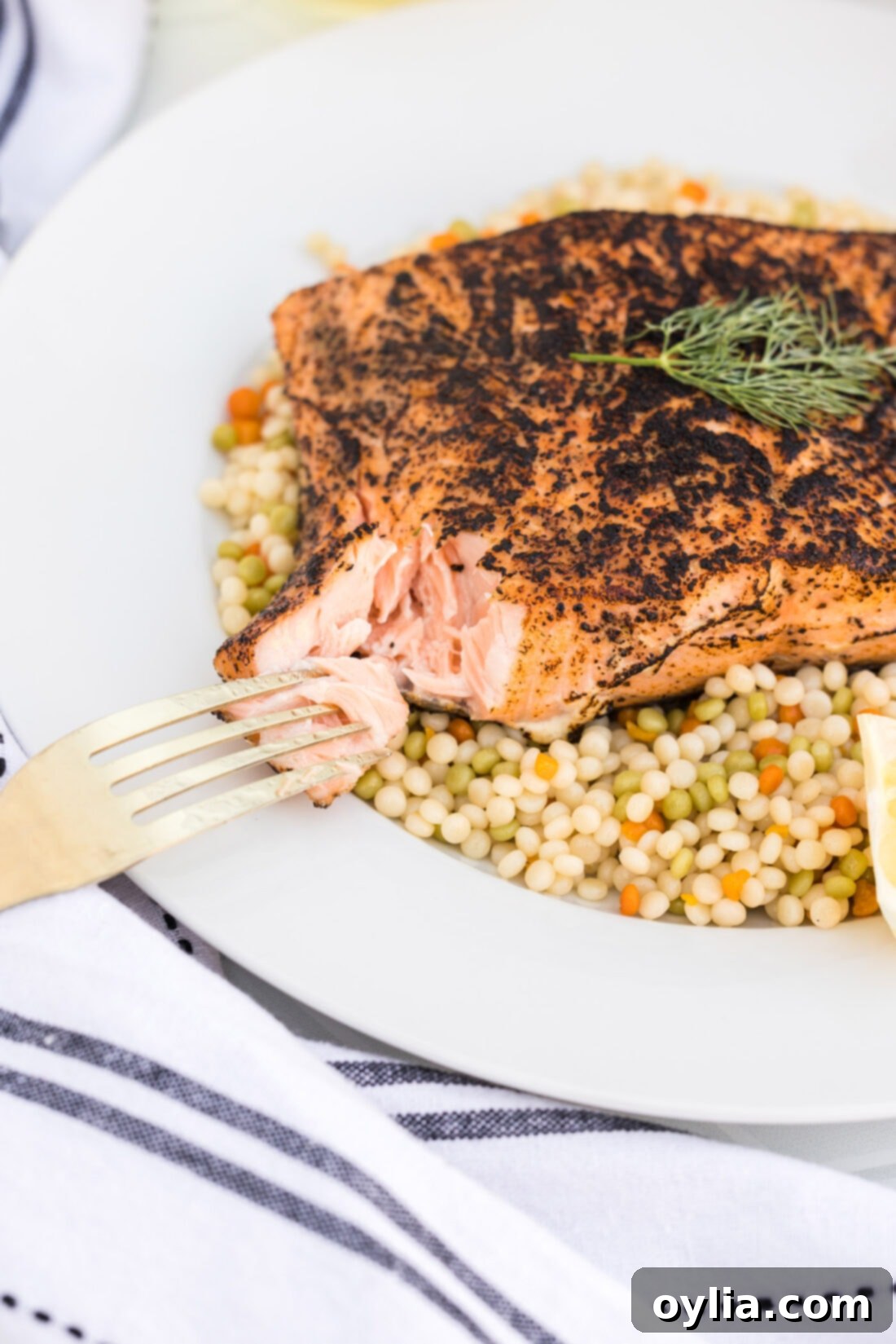 Perfectly cooked sous vide salmon on a plate, with a forkful showing its flaky texture