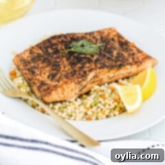 Sous Vide Salmon on a plate with a fork, highlighting its tender texture