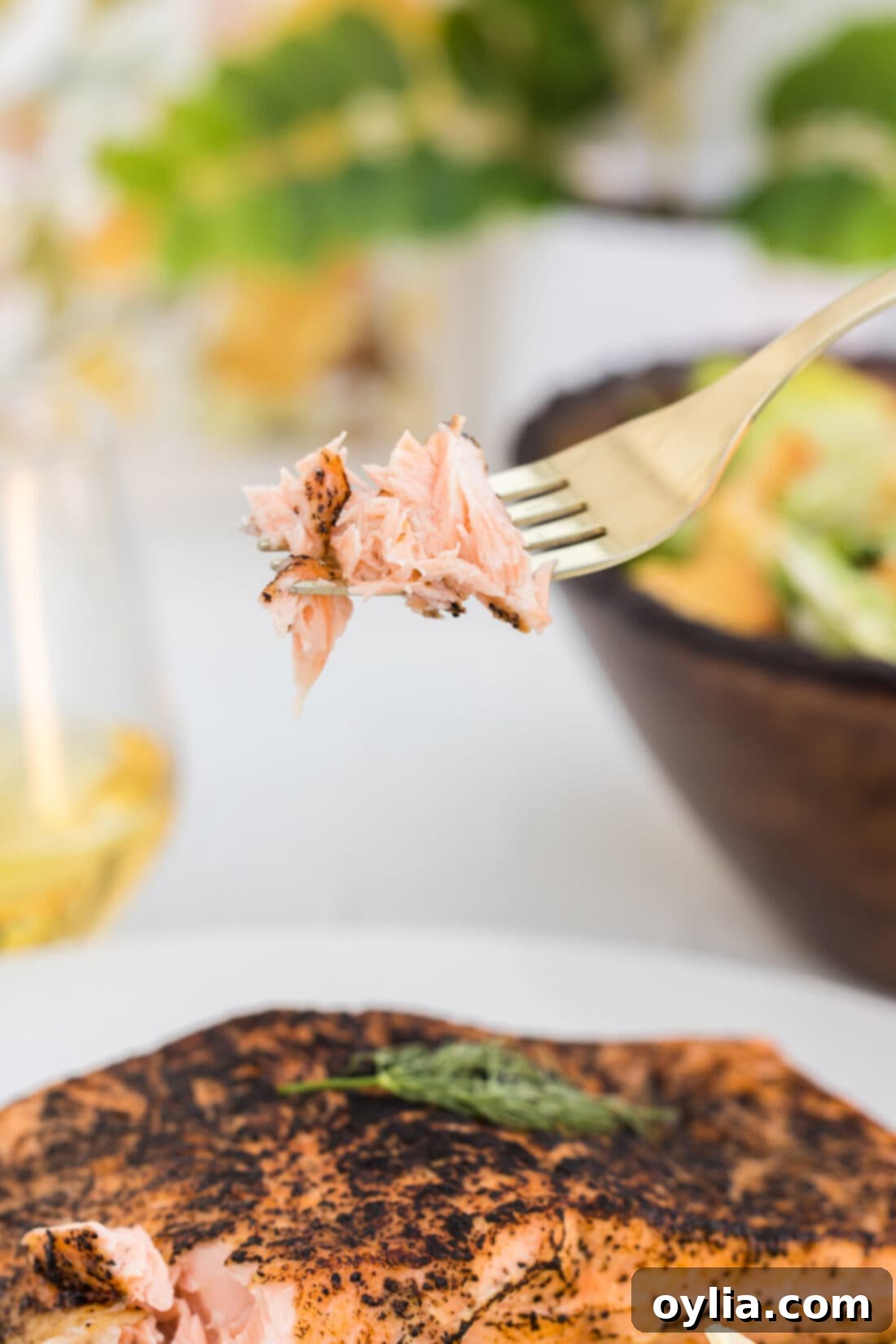 Close-up of a forkful of tender, flaky sous vide salmon