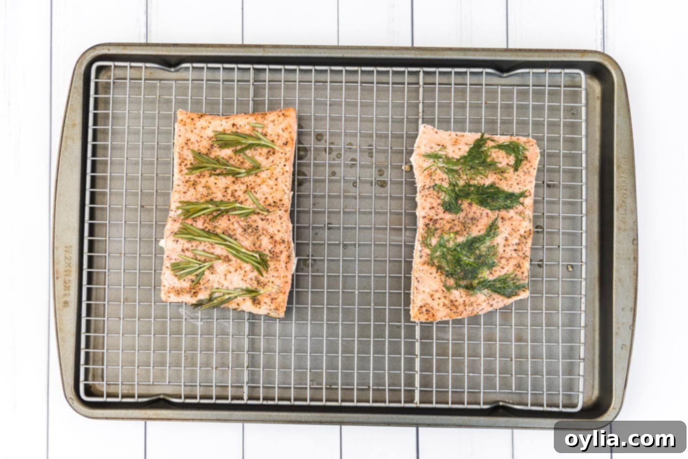 Perfectly cooked sous vide salmon filets removed from bags and placed on a wire cooling rack