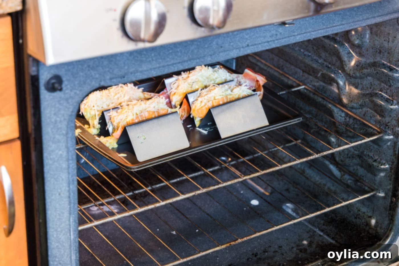 Lobster thermidor being broiled in the oven, with cheese melting and bubbling.