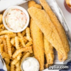 Golden Fried Whiting 13 Fried Whiting Fish in a metal serving dish with fries