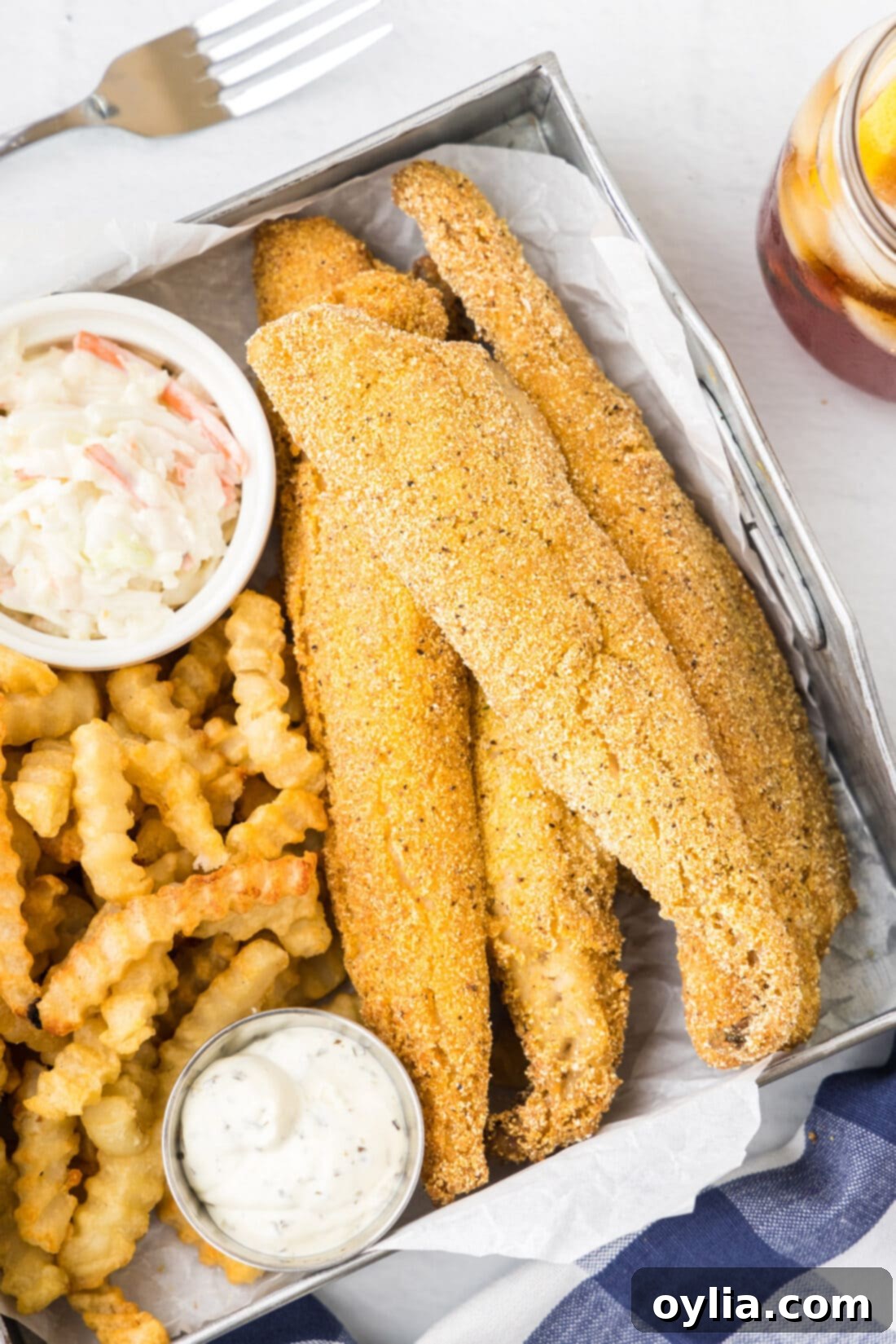 Golden Fried Whiting 3 Close-up of a perfectly fried whiting fish fillet, showing its golden-brown, crispy coating