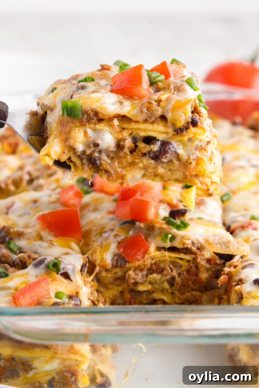 Enchilada Lasagna Bake 3 Piece of Mexican Lasagna on a spatula