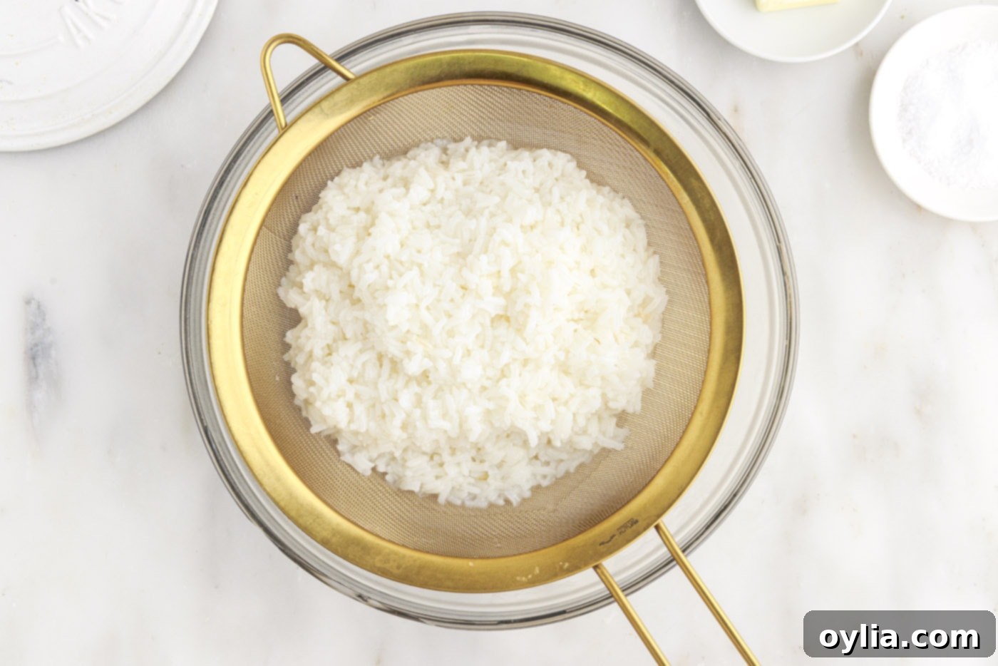 draining cooked rice in a bowl after boiling