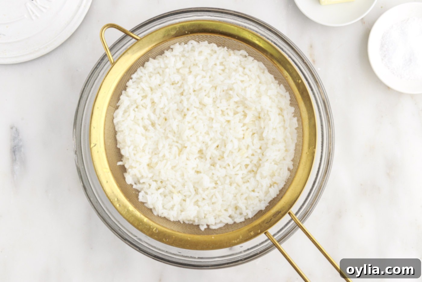 rice draining in a sieve after rinsing