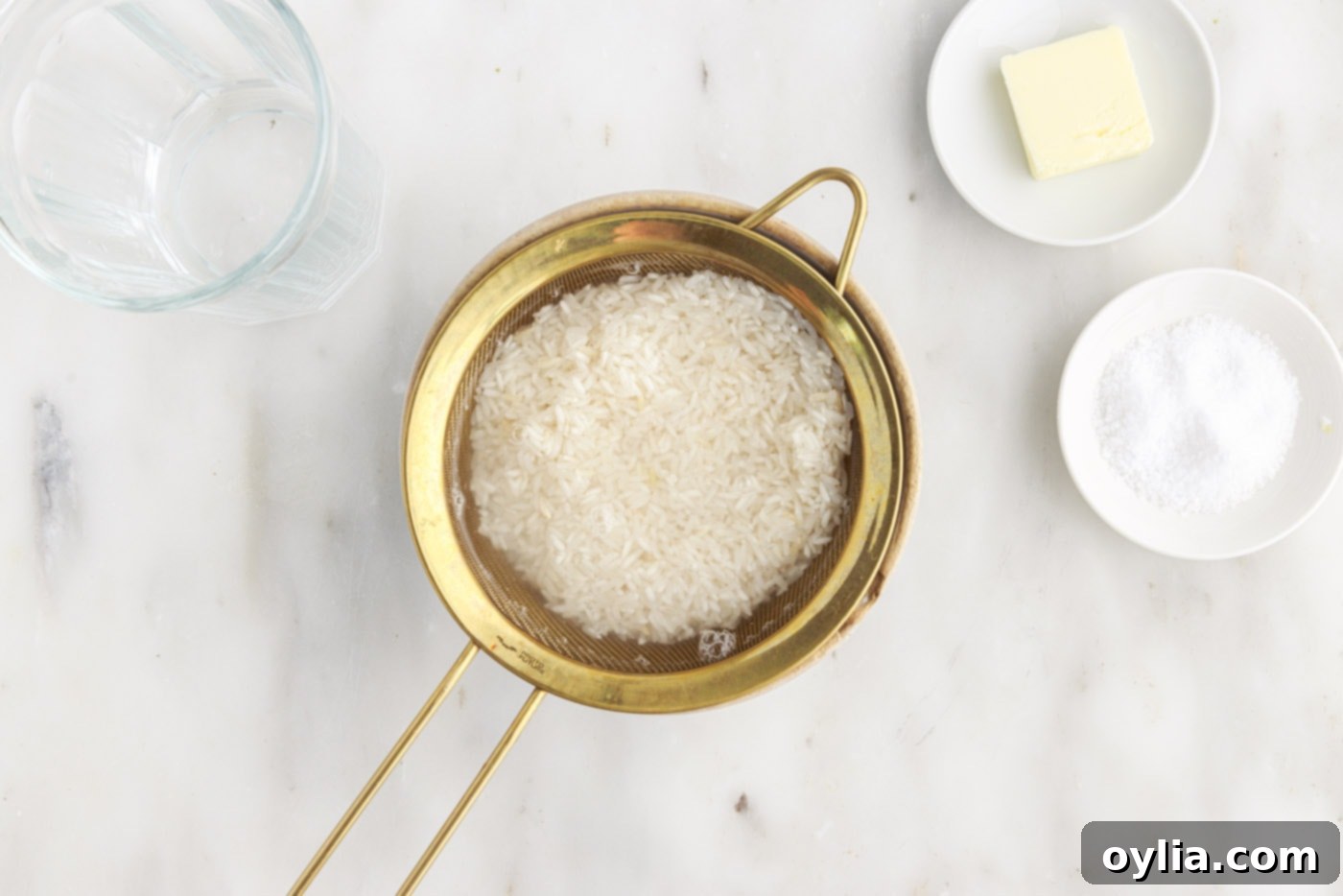 rinsing white rice with water in a sieve