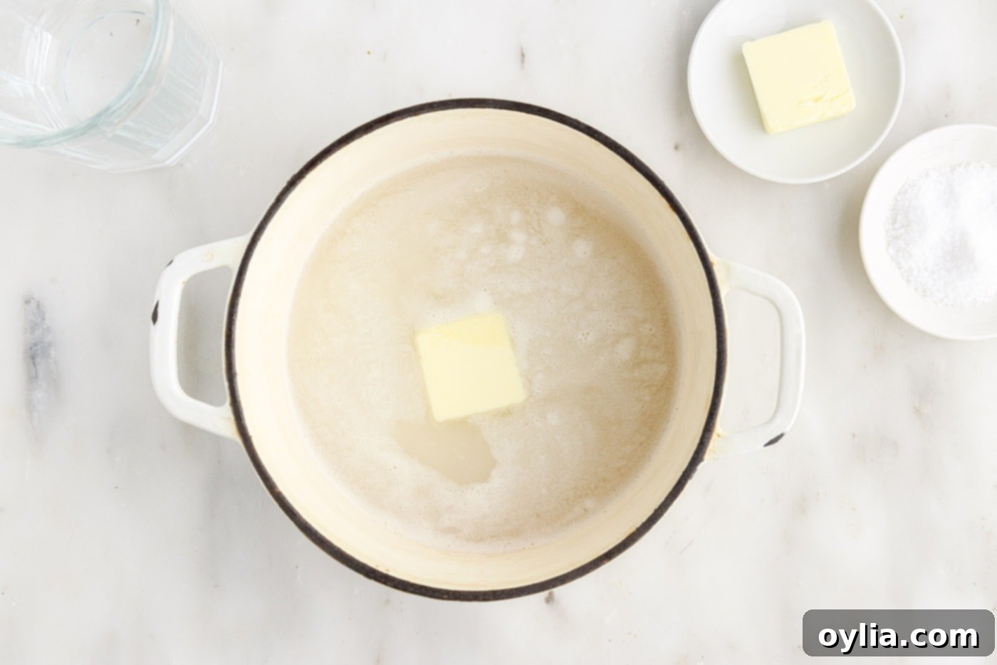 butter added to rice and water in a saucepan