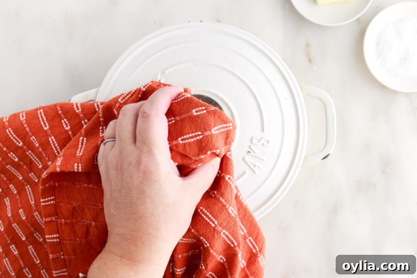placing lid over rice in a pot on the stovetop