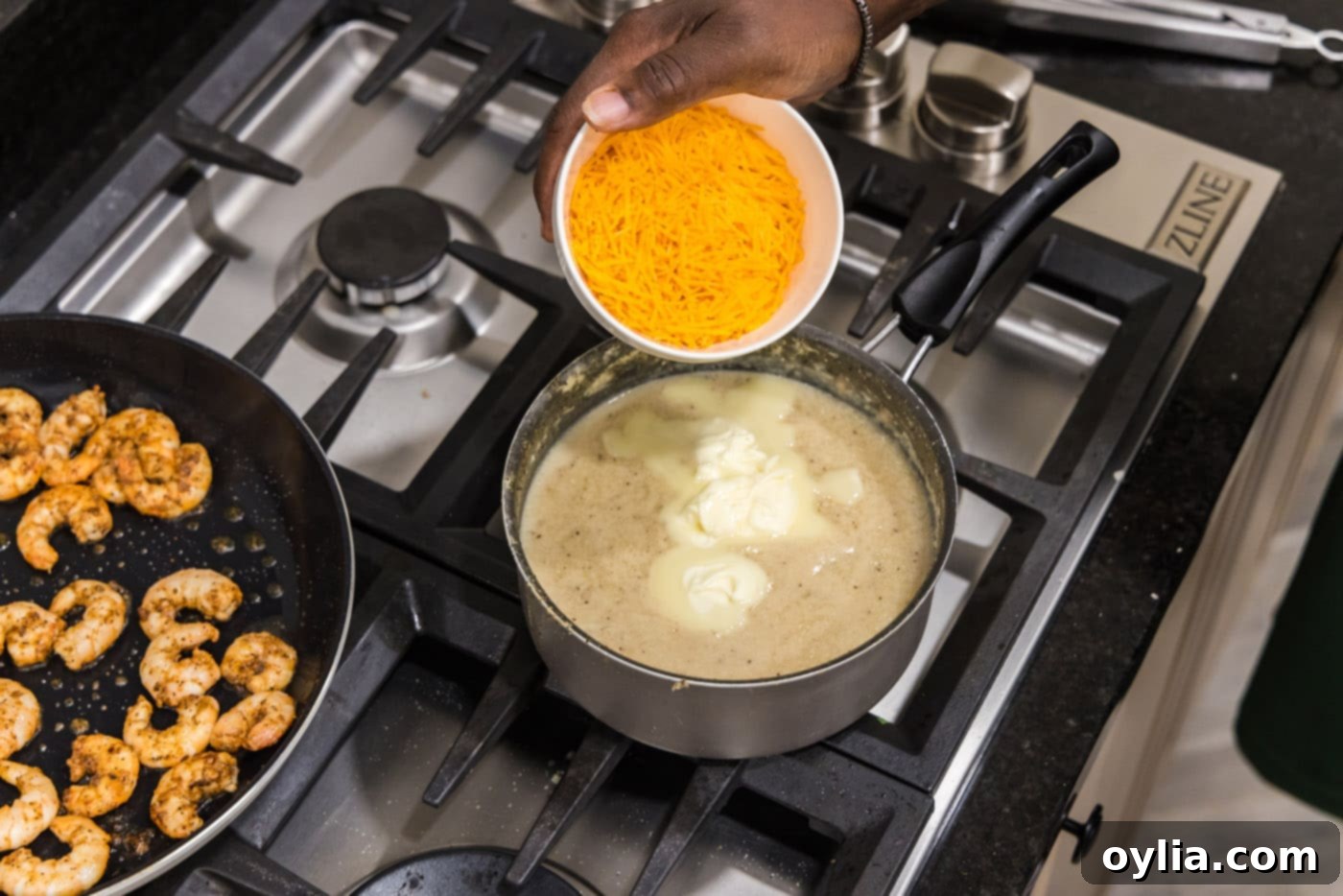 Adding shredded cheddar cheese to hot grits for a creamy finish.