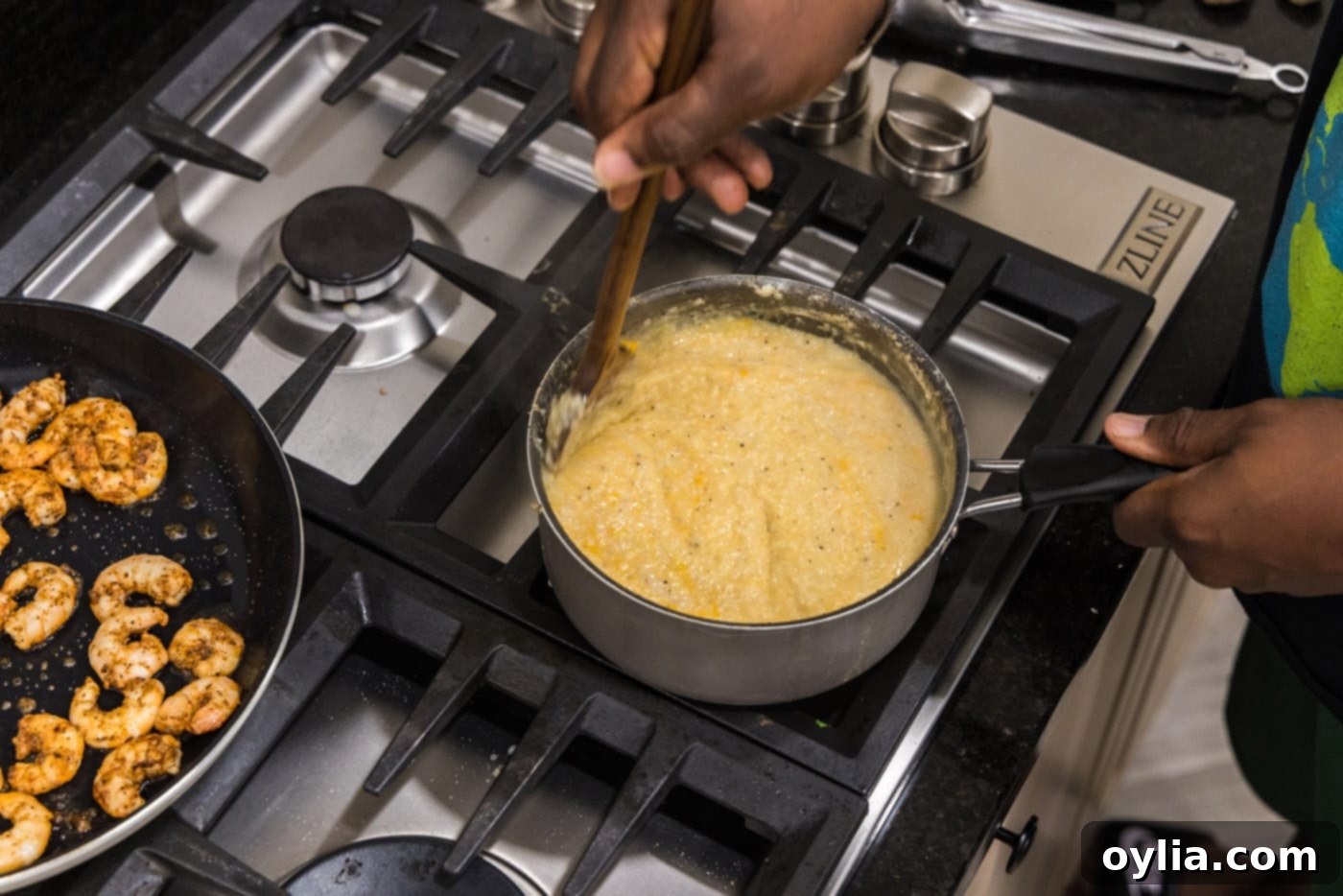 Stirring the cheesy grits until smooth and melted in the pot.
