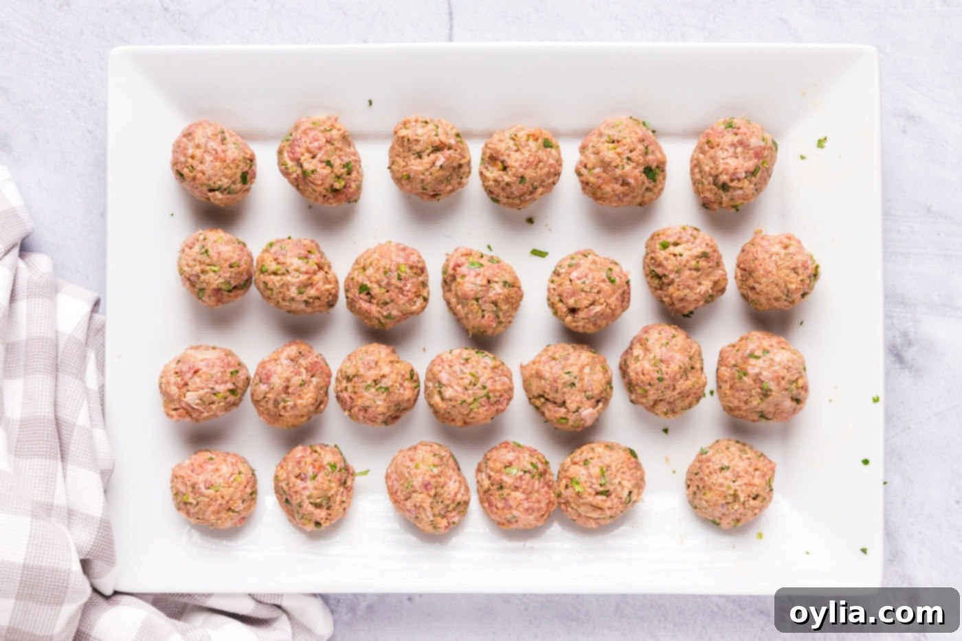 rolled lamb meatballs on a tray