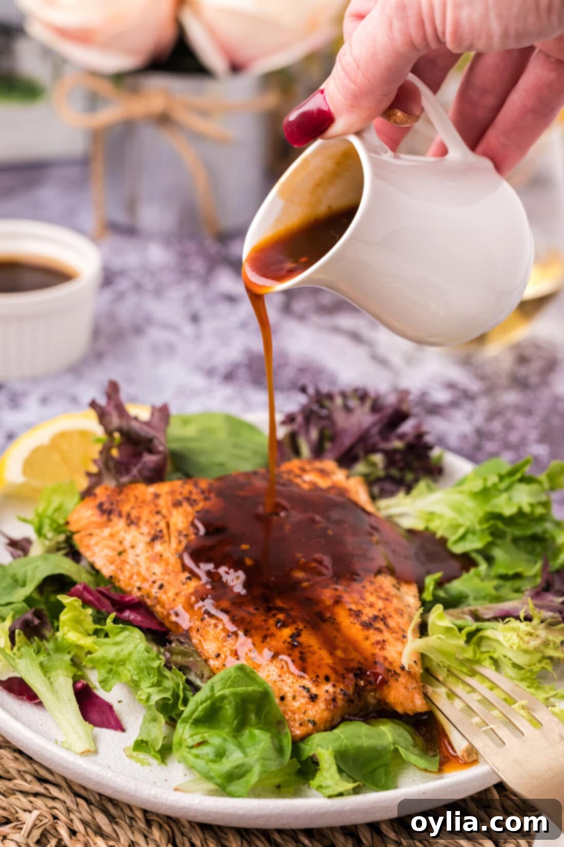 Salmon Sauce being drizzled on a piece of salmon