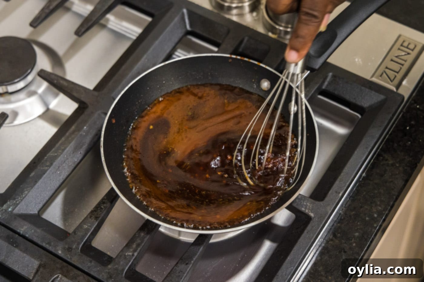 whisking salmon sauce in a skillet until thickened