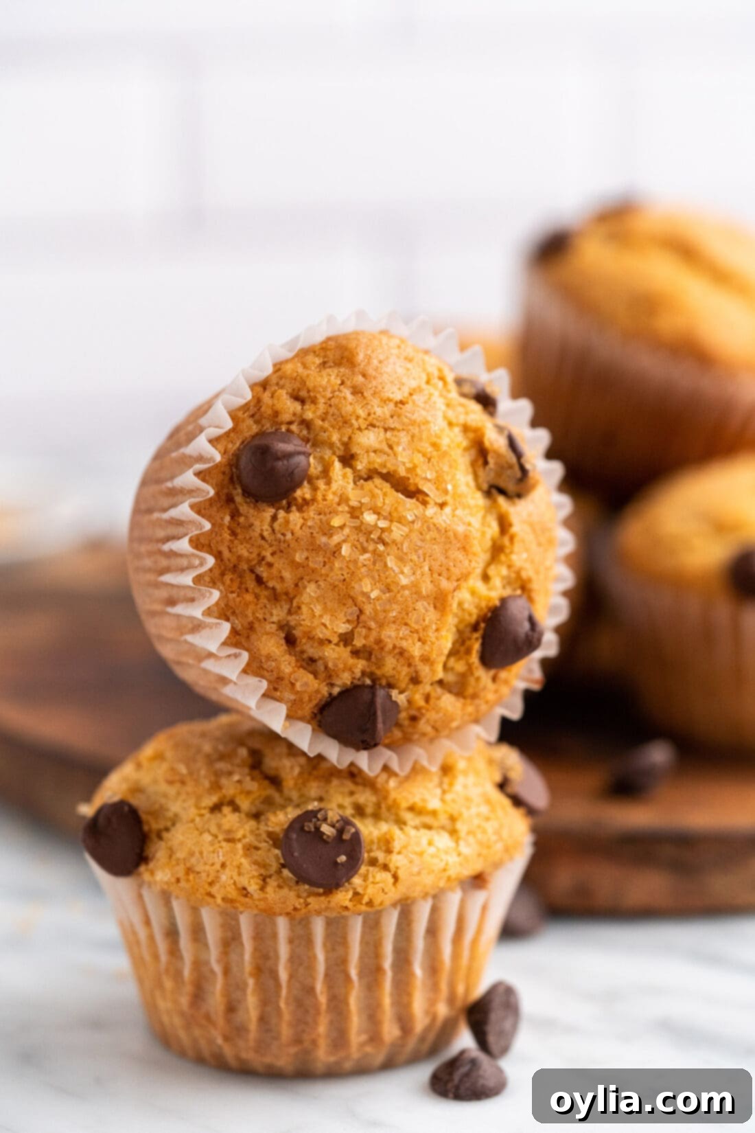 Irresistible Chocolate Chip Muffins 17 A stack of three soft chocolate chip muffins, highlighting their fluffy texture and delicious toppings.