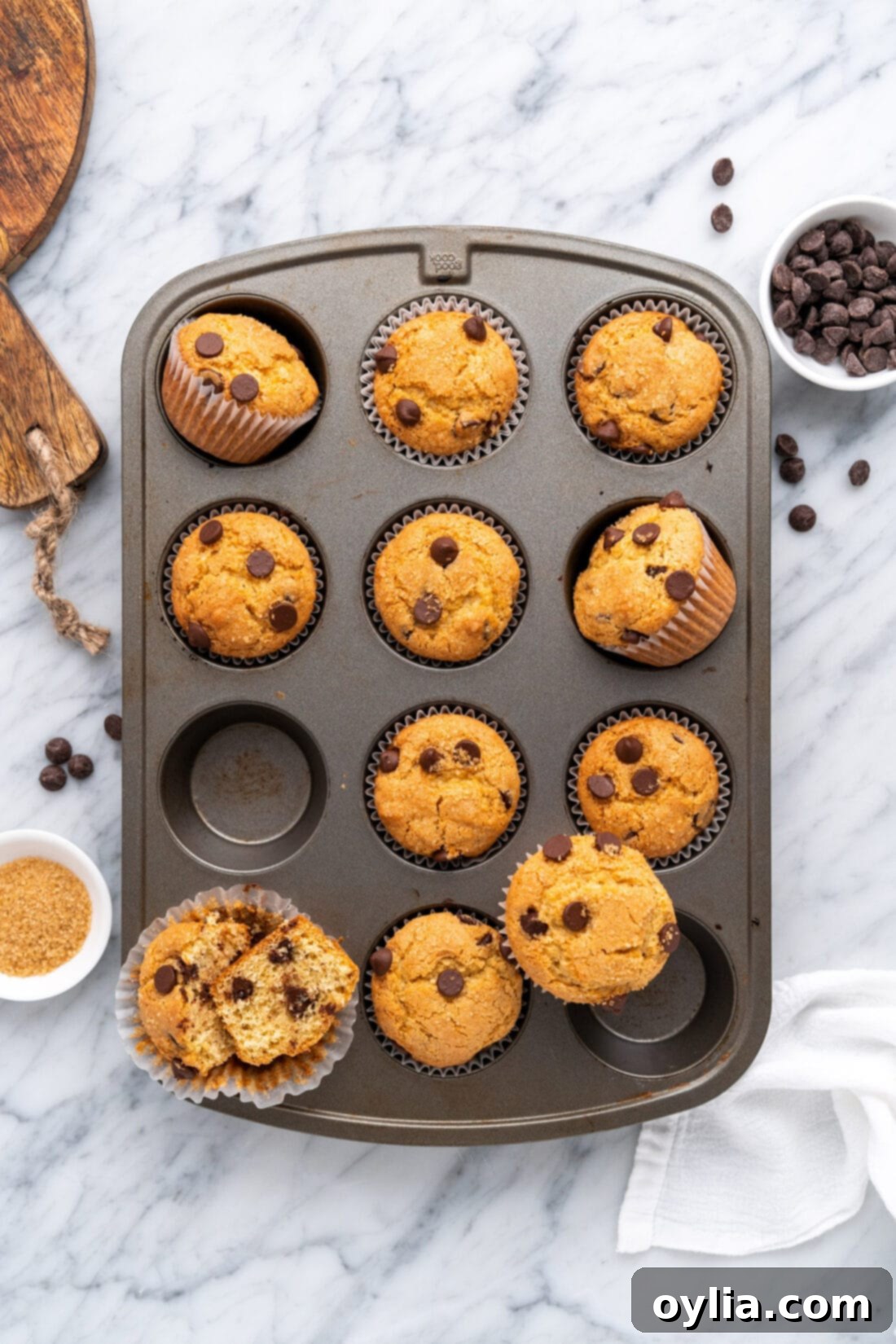 Irresistible Chocolate Chip Muffins 3 A muffin tin filled with freshly baked chocolate chip muffins, ready to be enjoyed.