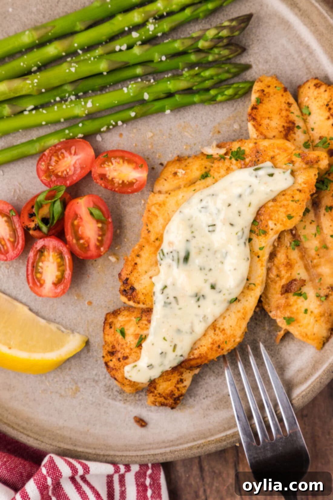 Pan-Seared Orange Roughy on a plate topped with a creamy rosemary sauce