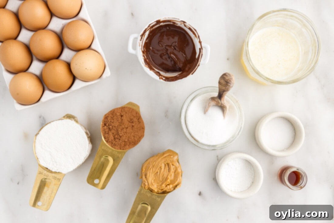 Various ingredients laid out for making Peanut Butter Brownies, including chocolate chips, butter, sugar, flour, and a jar of peanut butter.