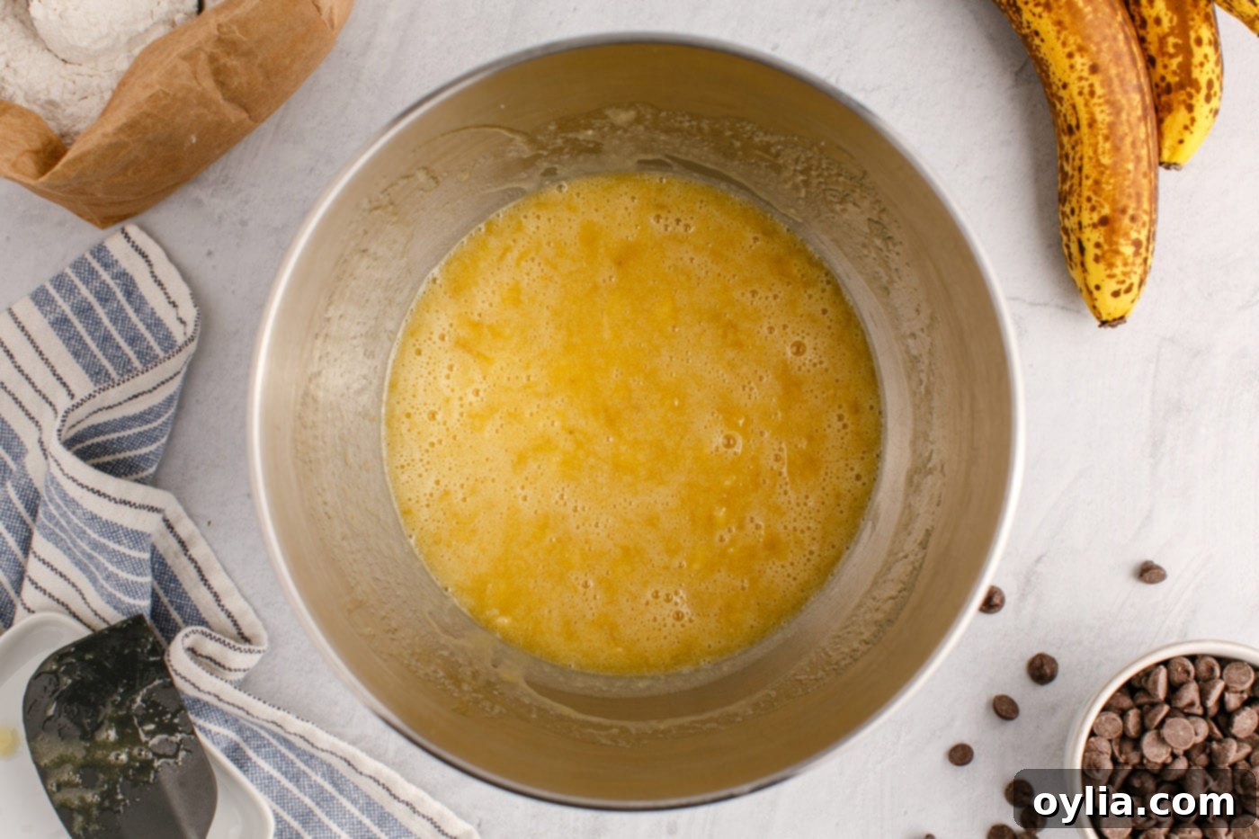 wet ingredients for banana bread in a stand mixer bowl