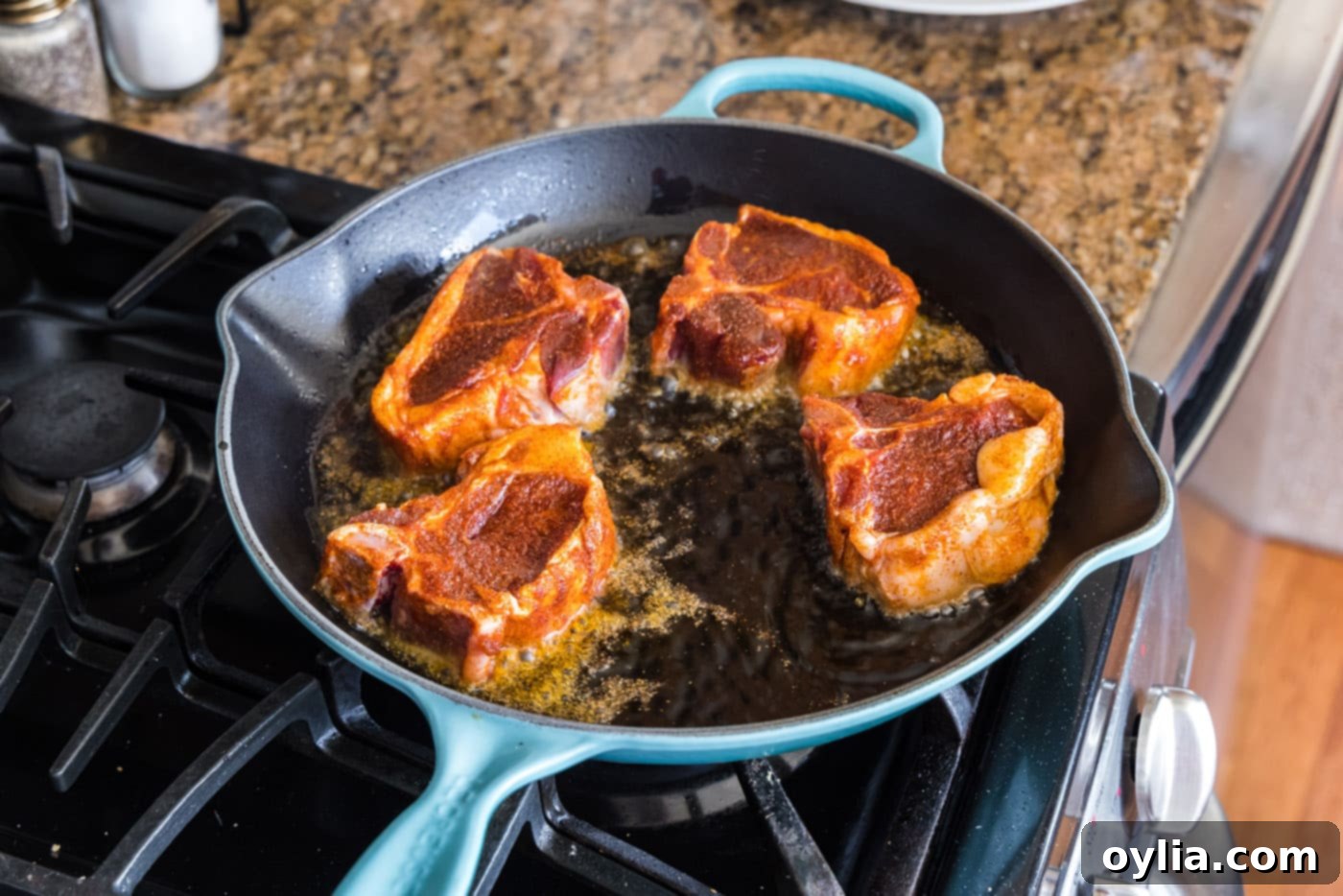 searing lamb chops in a skillet