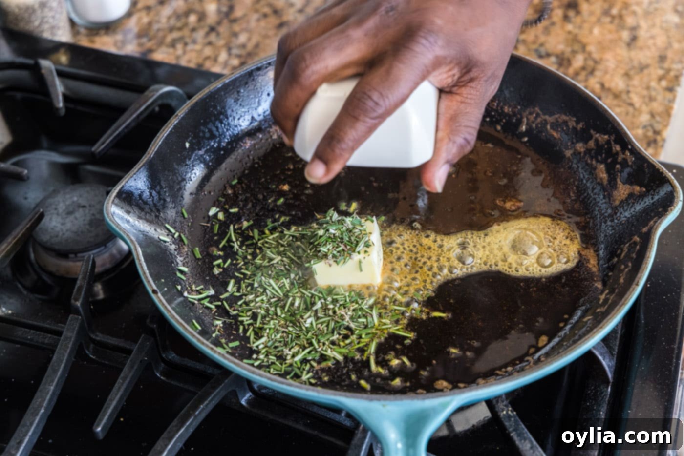adding butter and rosemary to skillet