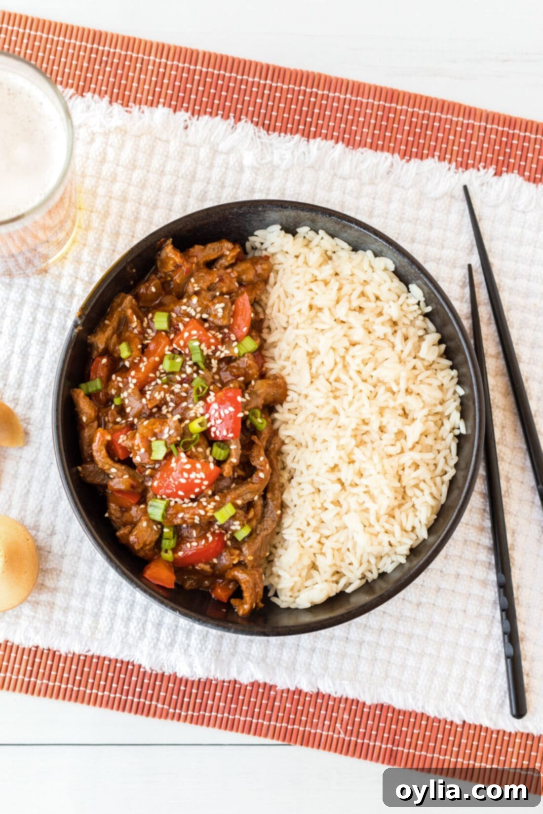 Overhead photo of Beijing Beef in a bowl with rice, ready to serve