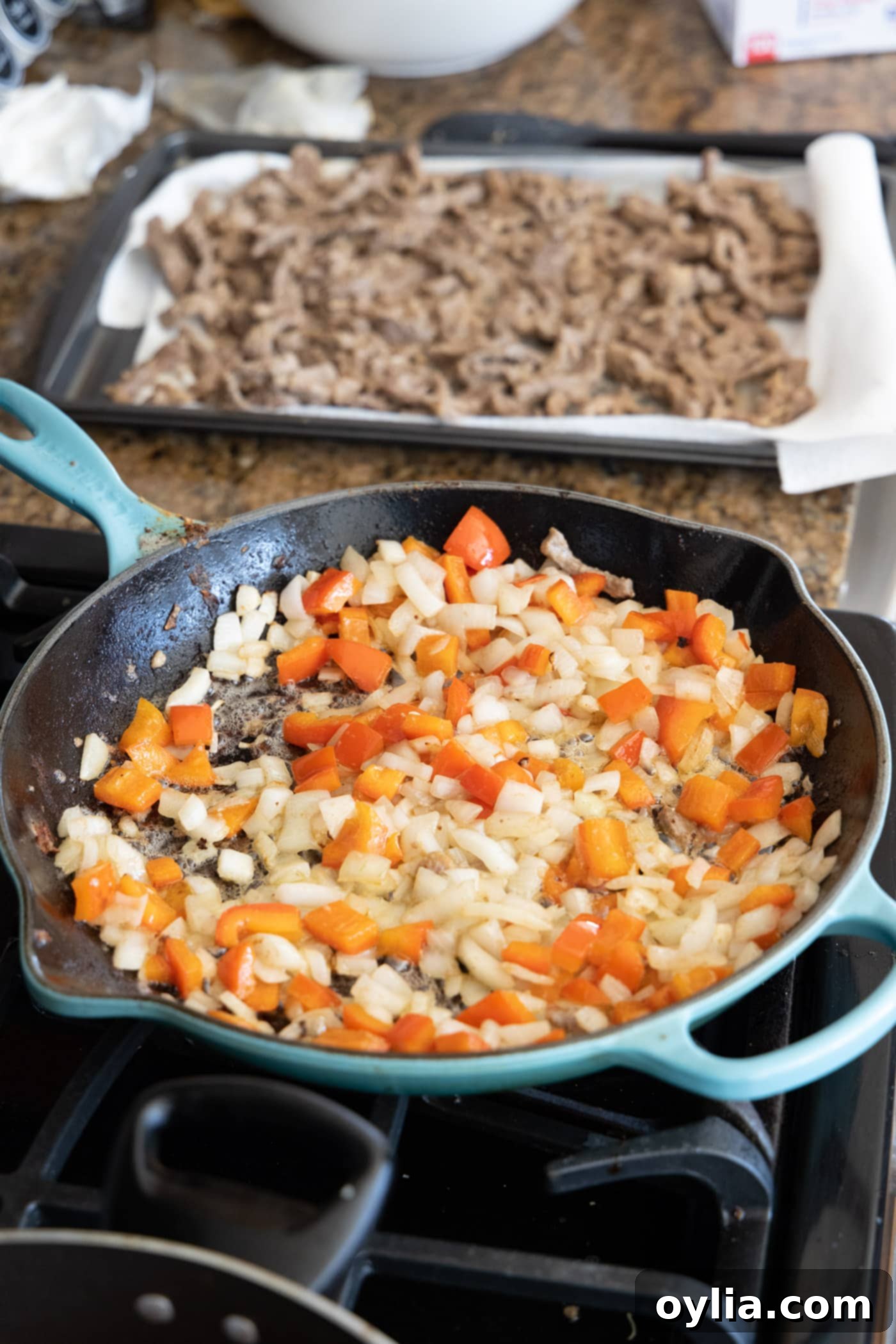 stir fried onion and bell pepper in a skillet
