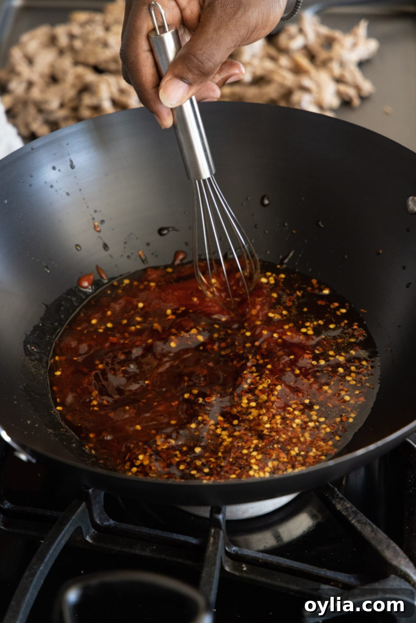 whisking beijing beef sauce ingredients in a wok