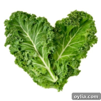 Fresh kale leaves arranged to form a heart shape, symbolizing health and nutrition.