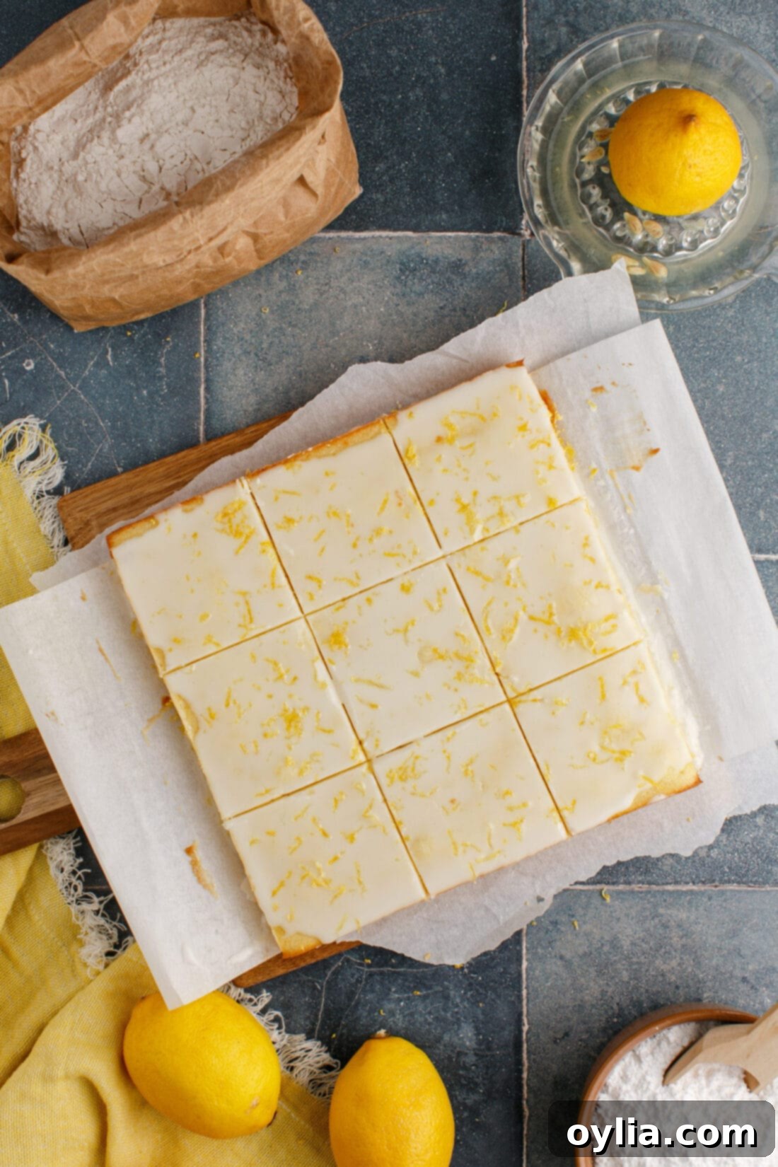 Zesty Lemon Brownies 2 Lemon Brownies cut into perfect squares on a rustic wooden cutting board, ready to be enjoyed.
