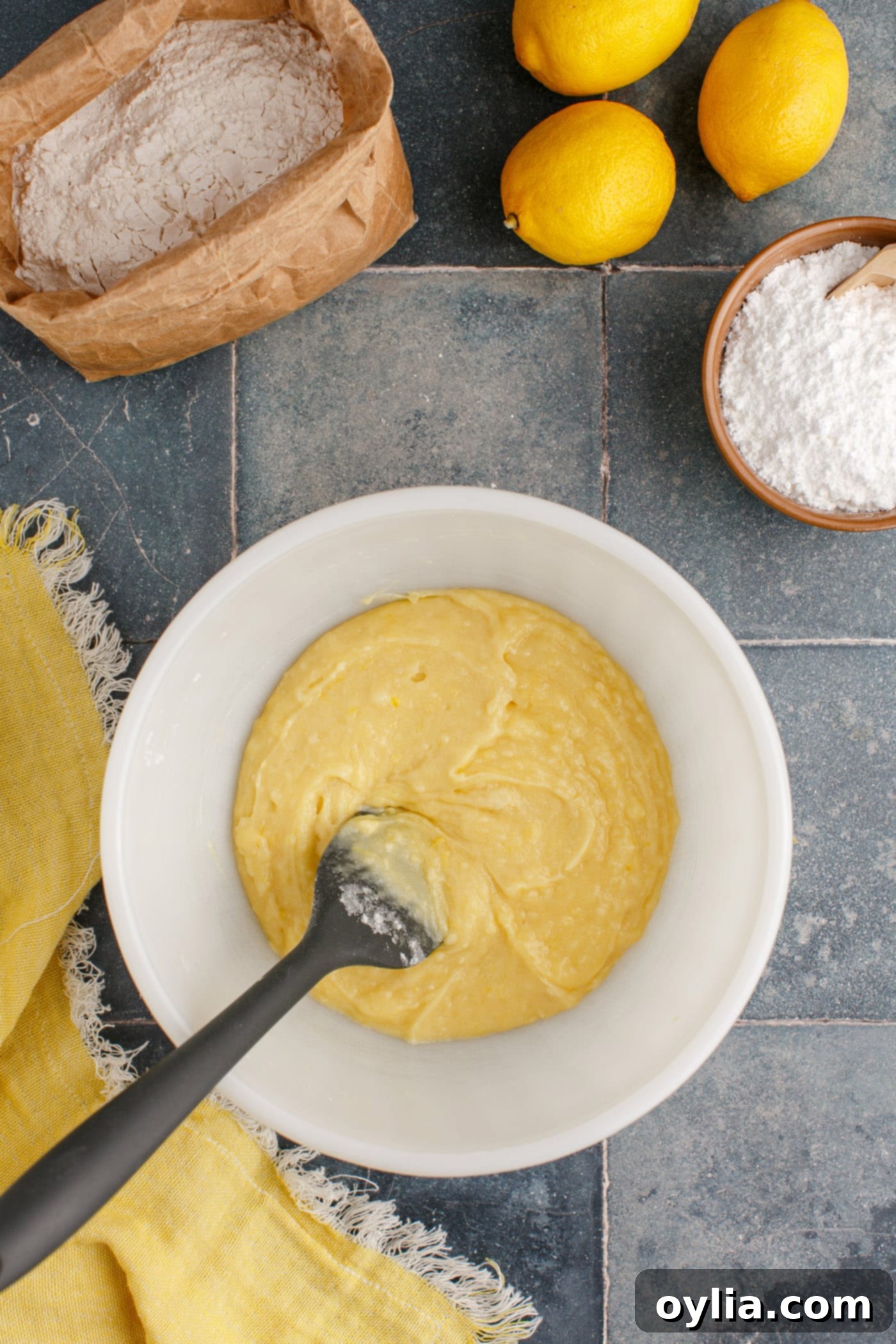 The lemon brownie batter in a mixing bowl, showcasing its smooth consistency after all ingredients have been combined.