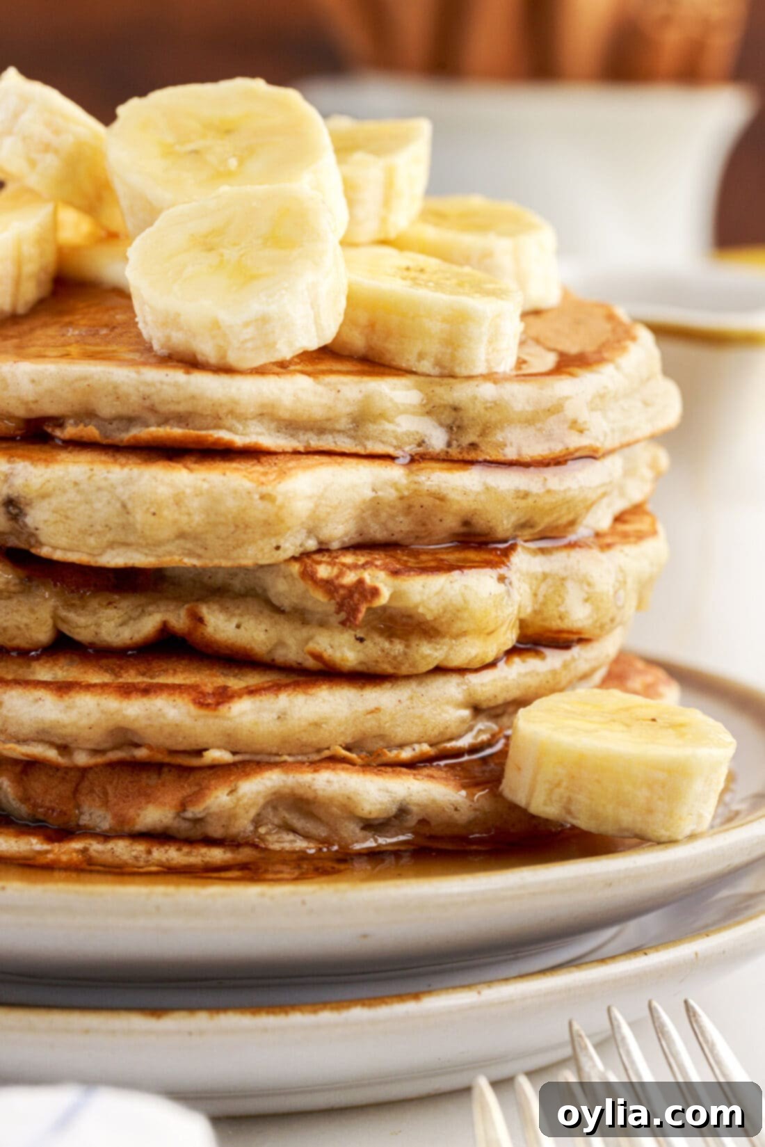 Fluffy Banana Bliss 13 Close up of a stack of golden brown, fluffy banana pancakes, highlighting their texture and appeal.
