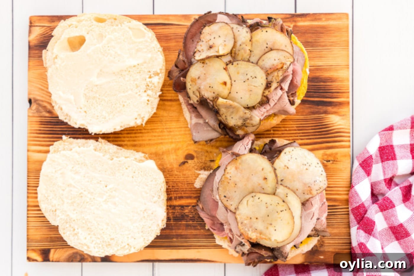 sliced potatoes on top of roast beef sandwich, adding another layer