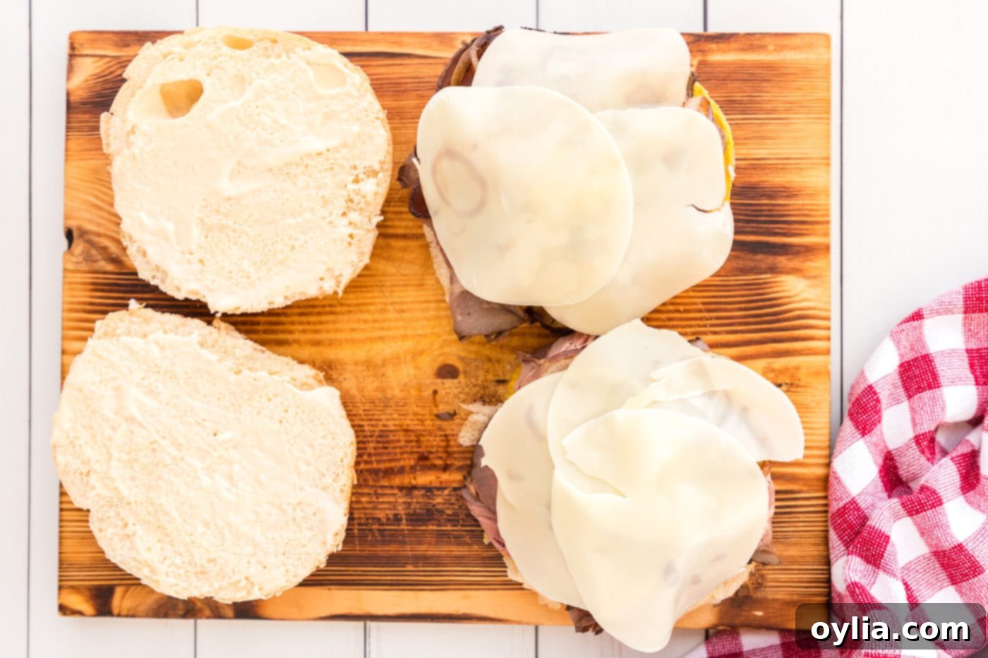 provolone cheese on top of roast beef sandwich, ready for the top bun