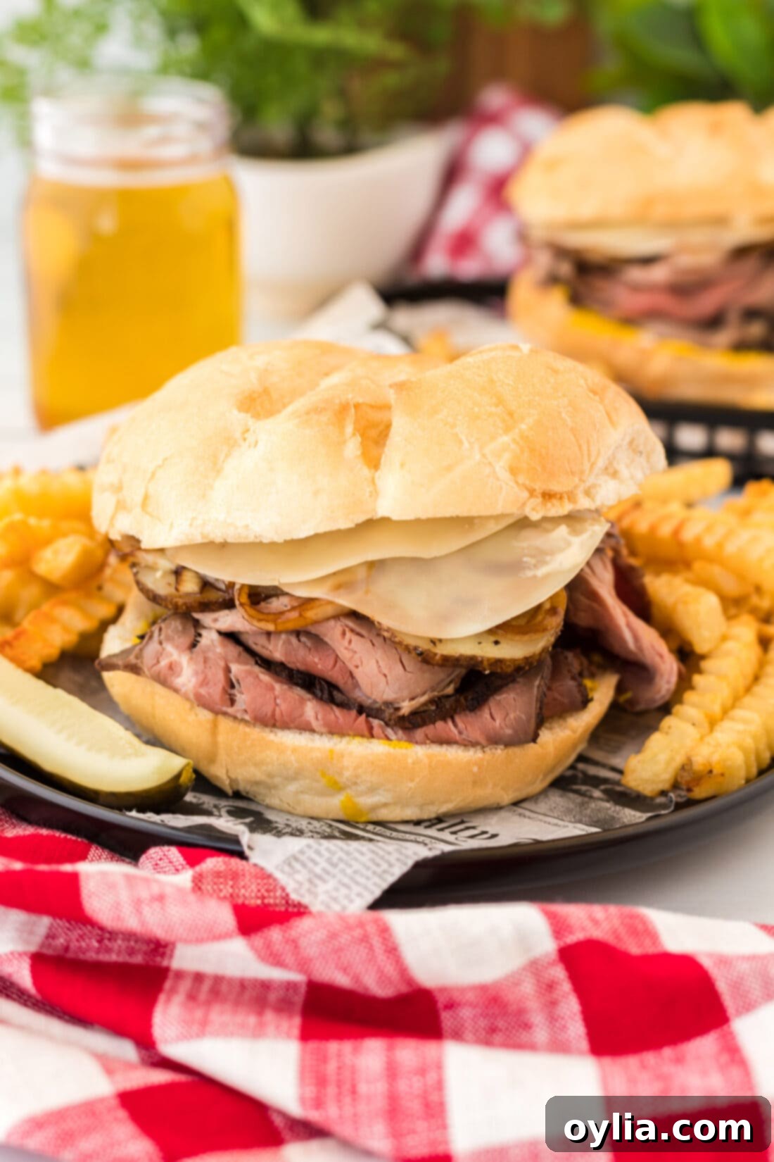 Tender Roast Beef Masterpiece 14 Roast Beef Sandwich on a plate with crinkle cut fries, a complete meal