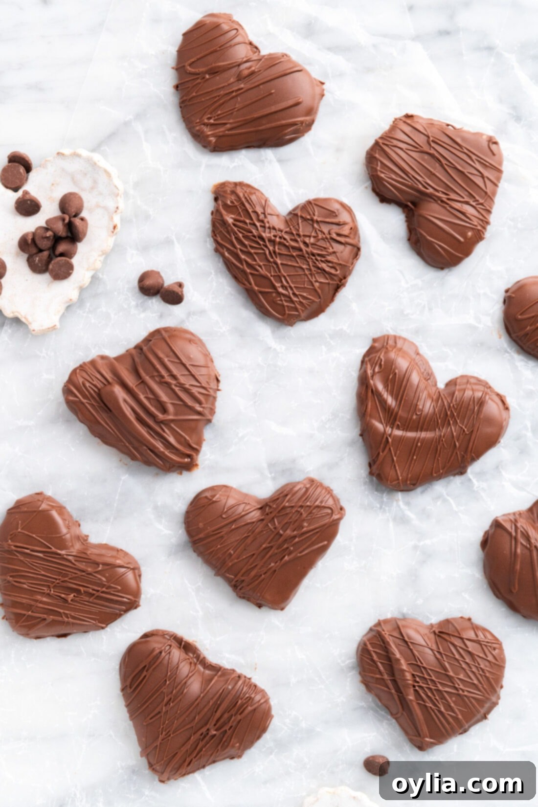 Chocolate Peanut Butter Hearts on a piece of parchment paper with chocolate chips