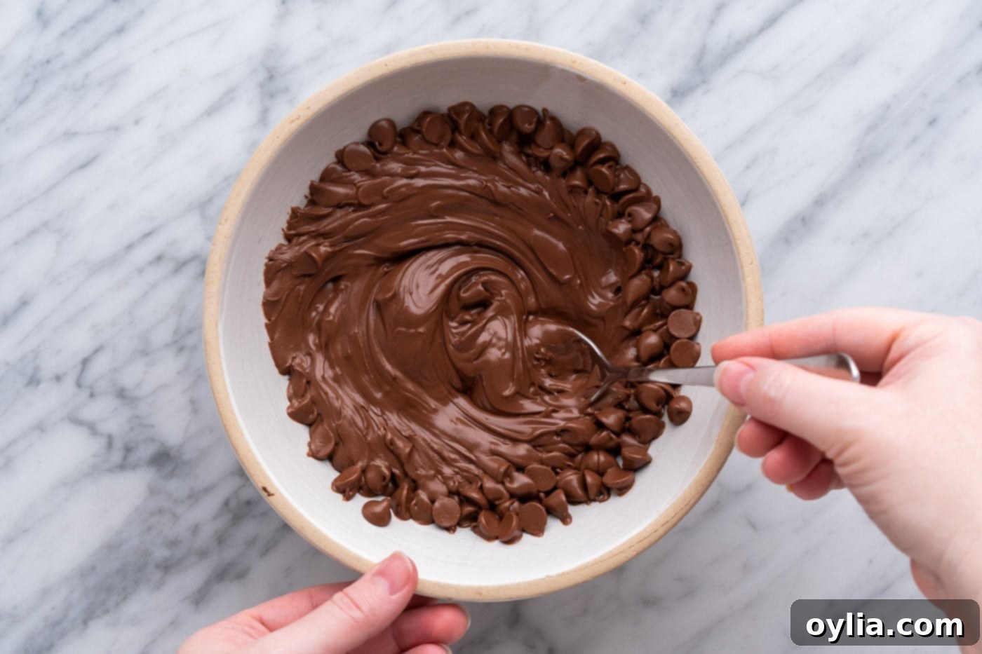 stirring melted chocolate chips in a bowl