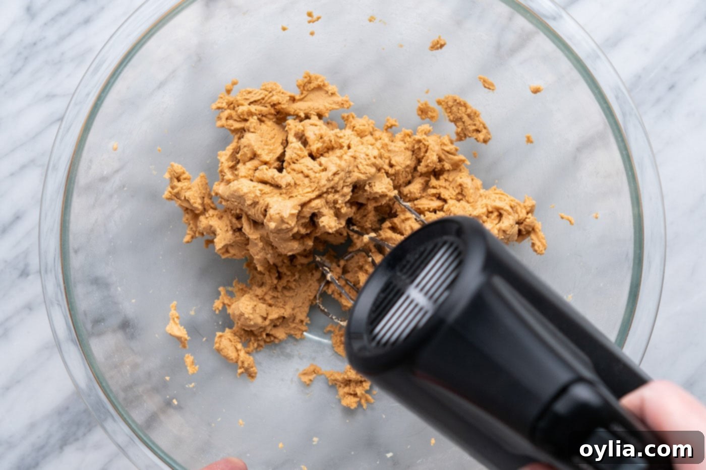 Electric mixer combining peanut butter and powdered sugar