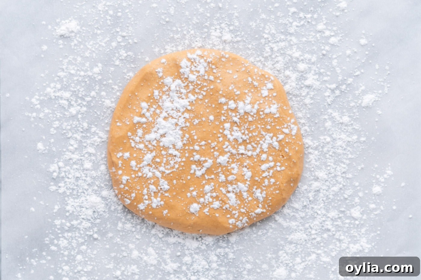 peanut butter dough laid flat with powdered sugar sprinkled on top