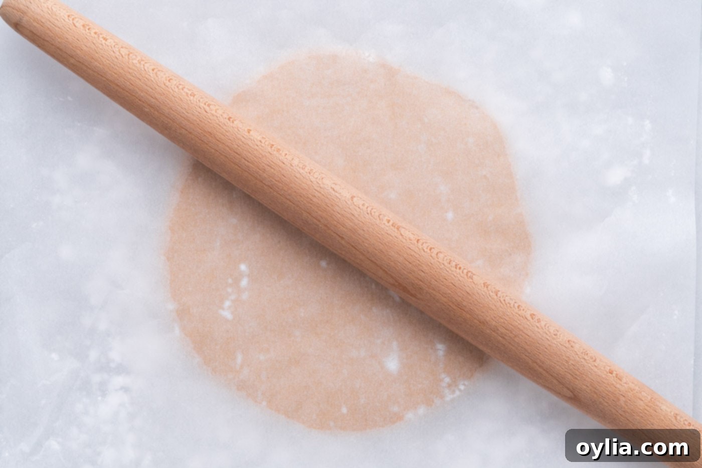 rolling the peanut butter dough ball with a rolling pin
